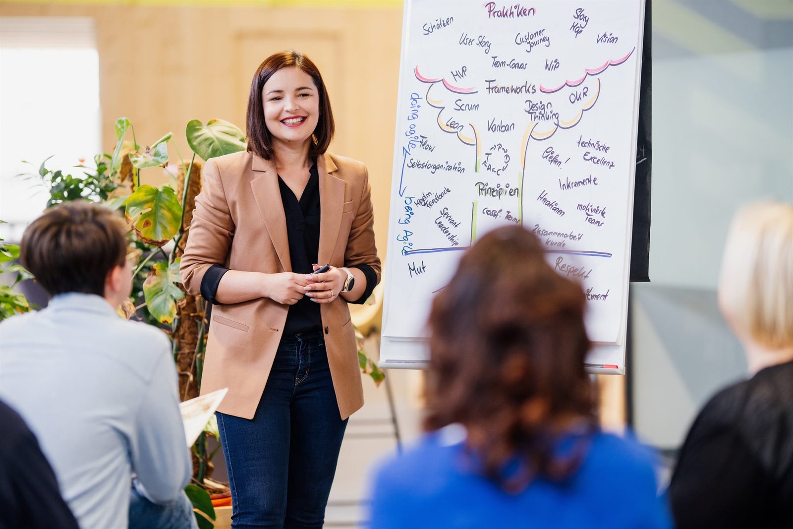 Sevdalina Pandova moderiert einen Workshop am Flipchart vor einer Gruppe
